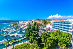 A coastal town with a marina, buildings, and a prominent church.