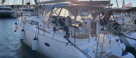 Un yacht blanc, baptisé « Impression 434 », était amarré dans une marina, aux côtés d’autres yachts. On pouvait y voir une bannière de site web avec l’adresse « WWW.JADRANKYACHTING.COM » et un logo représentant « QUAHOLIC ».