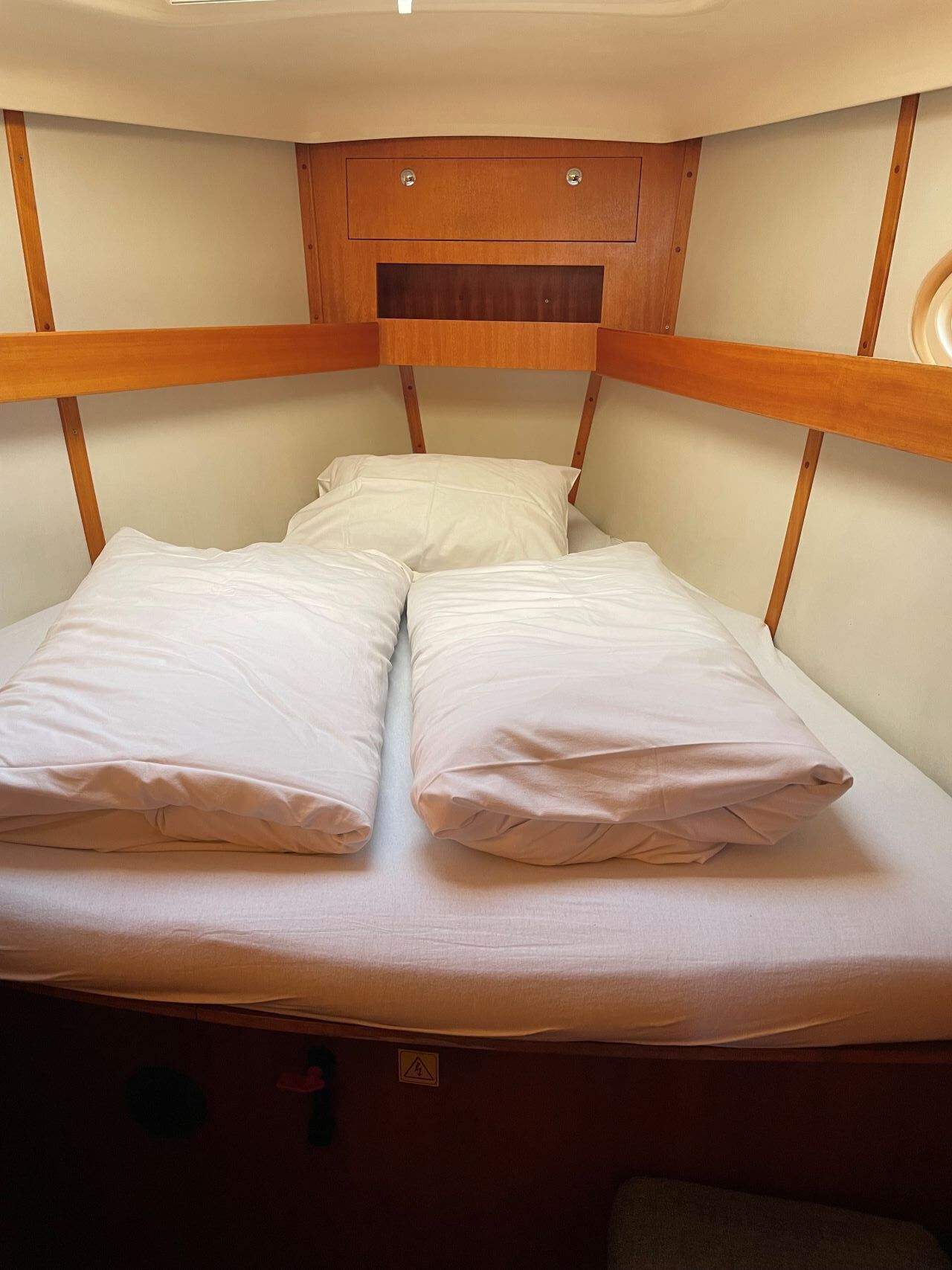 A bunk bed with two pillows and a headboard.