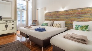 A hotel room with two beds, a large window, a mirror, and a colorful wall. - CR2 in Lisboa Ciudad (Lisbon)