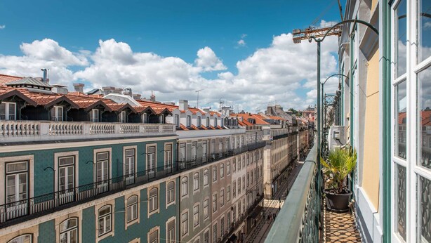 A row of traditional European buildings with red-tiled roofs and balconies. - CN1 in Lisboa Ciudad (Lisbon)