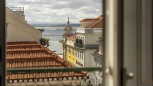 A view of buildings with a river and a bridge in the background. - CN1 in Lisboa Ciudad (Lisbon)