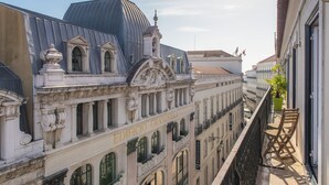 A historic building with ornate architecture, a balcony with chairs, and a clear view of the street below. - CH1 in Lisboa Ciudad (Lisbon)