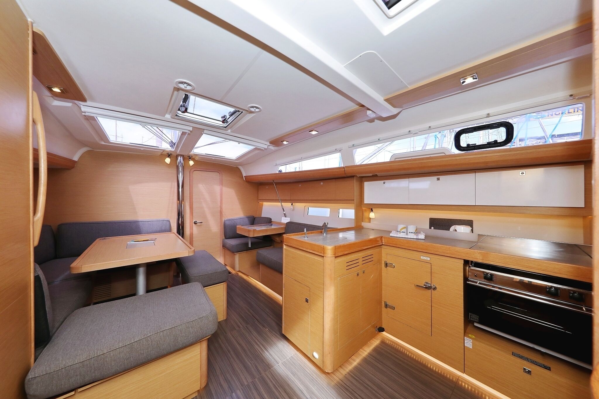 A compact kitchen with a dining area, built-in oven, and a small table.