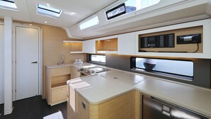 A compact kitchen with built-in appliances, a window for natural light, and a control panel above the stove. - Sun-Kissed Sailing Adventure in Istria, Croatia (Pula)