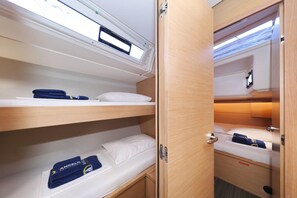 A compact, well-lit room with bunk beds and a small storage area. - Sun-kissed Sailing Adventure in Split-Dalmatia, Croatia (Trogir)