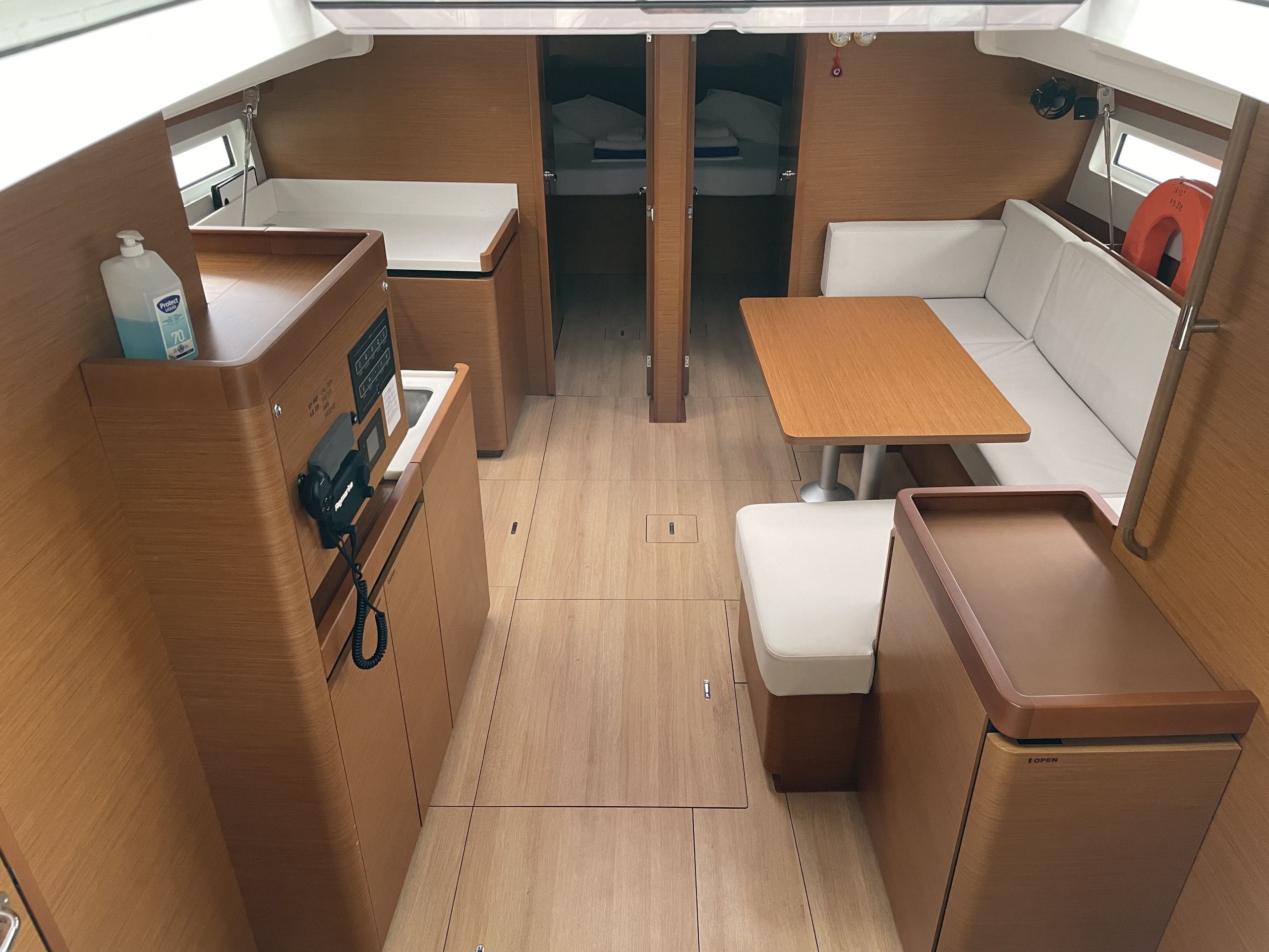 A compact interior with a kitchenette, a dining area, and a seating space.