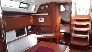 A compact galley with a sink, stove, and storage cabinets. - Sun-Kissed Sailing Adventure in Split, Croatia (Split)