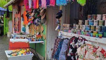 A shop with various colorful fabrics and clothing items displayed outside.