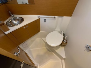 A compact bathroom with a sink, toilet, and bathtub. - Sun-Kissed Sailing Adventure in the Sporades Islands from Volos, Thessaly (Volos)