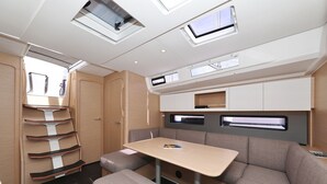 A compact RV interior with a dining area, storage cabinets, and a window. - Sun-Kissed Sailing Adventure in Sibenik, Croatia (Primošten)