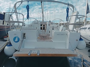 A yacht deck with a wooden floor, steering wheel, and the name 'AIR TIME 1' on the side. - Sun-Kissed Sailing Adventure in Istria, Croatia (Pula)