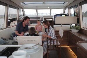 A family dining on a boat with a view of the water. - Sun-Kissed Sailing Adventure in Istria, Croatia (Pula)