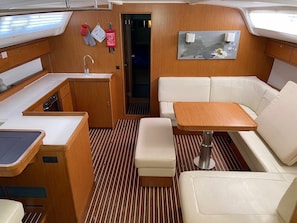 A compact galley with a sink, stove, and storage cabinets. - Sun-Kissed Sailing Adventure in Istria, Croatia (Vrsar)