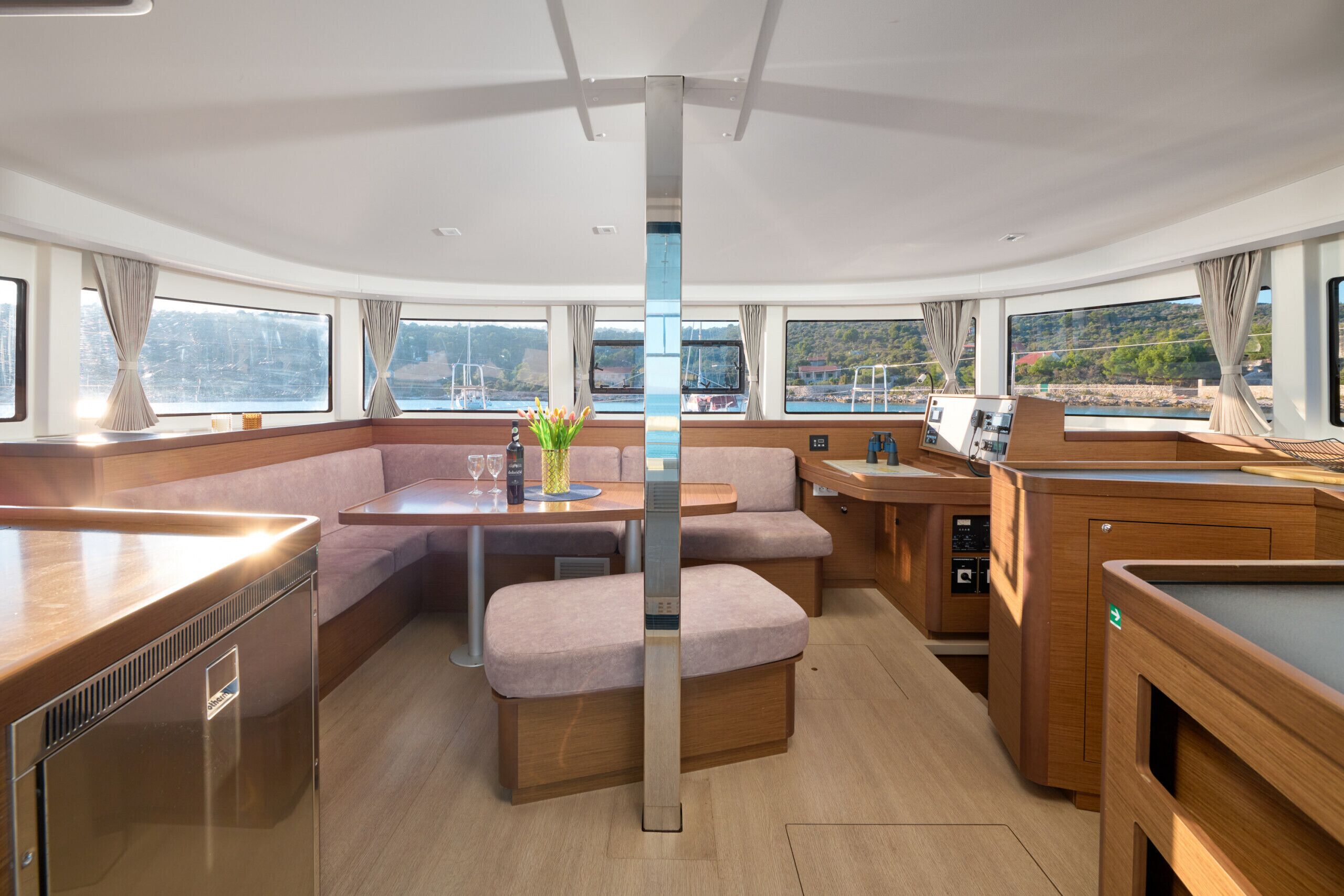 A modern interior with a dining area, seating, and a kitchen.