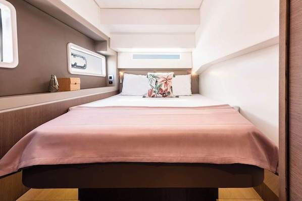 A compact, well-lit room with a bed, a small table, and a window. - Sun-kissed Sailing Adventure in Split-Dalmatia, Croatia (Seget Donji)