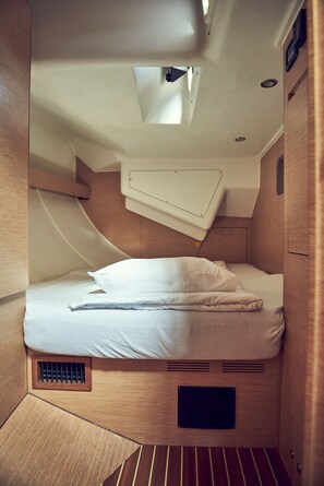 A compact, well-lit cabin with a bunk bed, a small skylight, and built-in ventilation. - Sun-Kissed Sailing Adventure in Istria, Croatia (Pula)