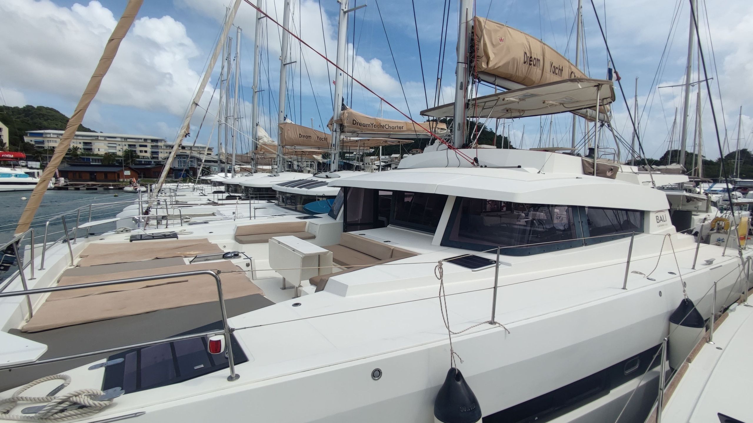 A marina with multiple yachts docked.
