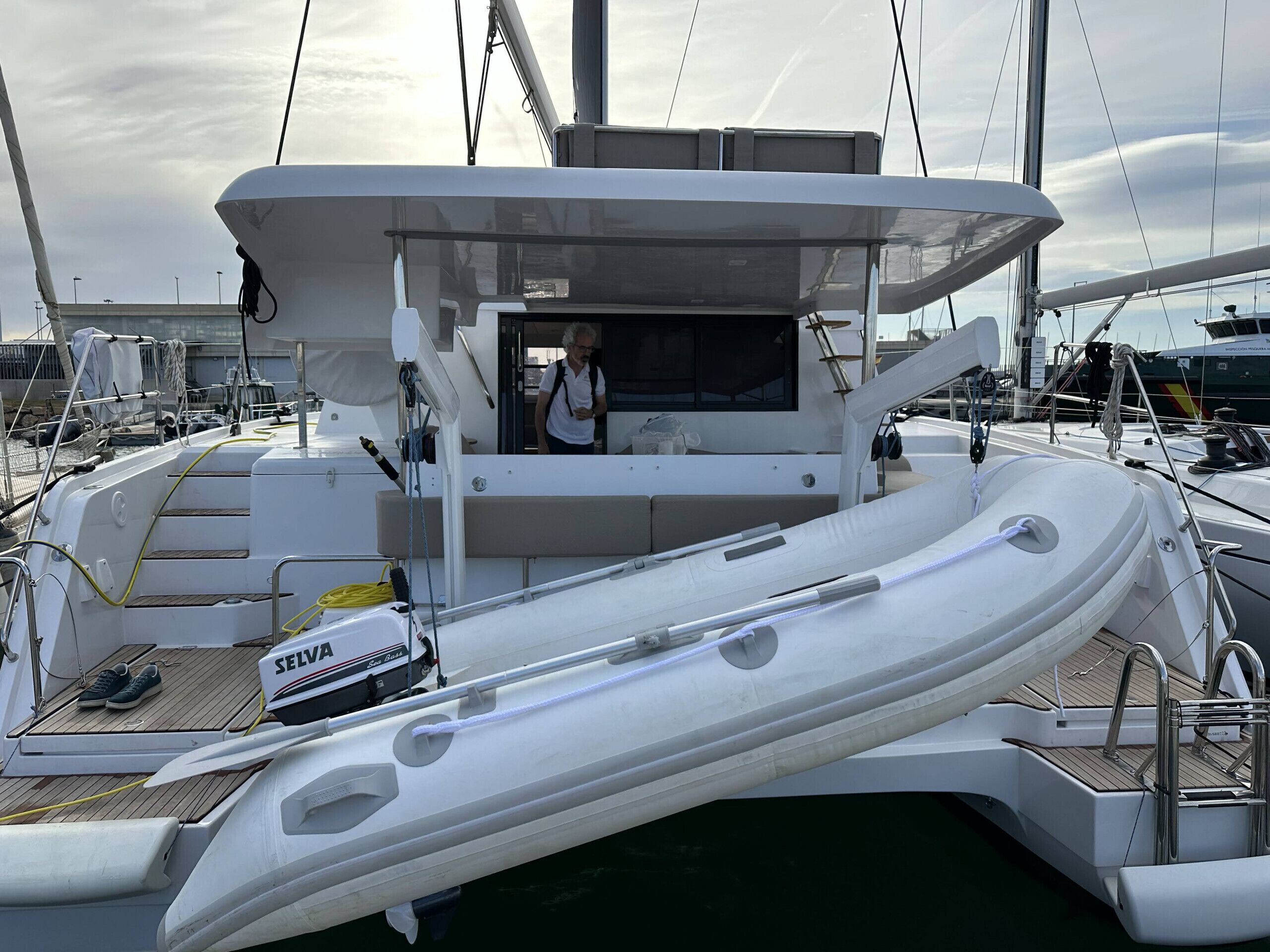 A yacht with a covered deck, a seating area, and a motorized outboard.