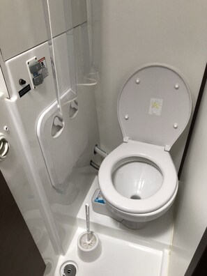 A compact, modern bathroom with a toilet, bidet, and hand dryer. - Sun-Kissed Sailing Adventure in Sibenik, Croatia (Rogoznica)
