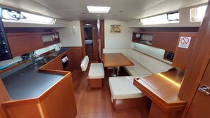 A compact galley with a sink, stove, and storage cabinets.
