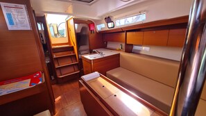 A compact kitchen with a sink, a small countertop, and wooden cabinets. - Sun-Kissed Sailing Adventure in Sibenik, Croatia (Zaton)