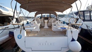 A VUSCHI yacht with a covered deck, multiple steering wheels, and a central seating area. - Sun-Kissed Sailing Adventure in Istria, Croatia (Pula)