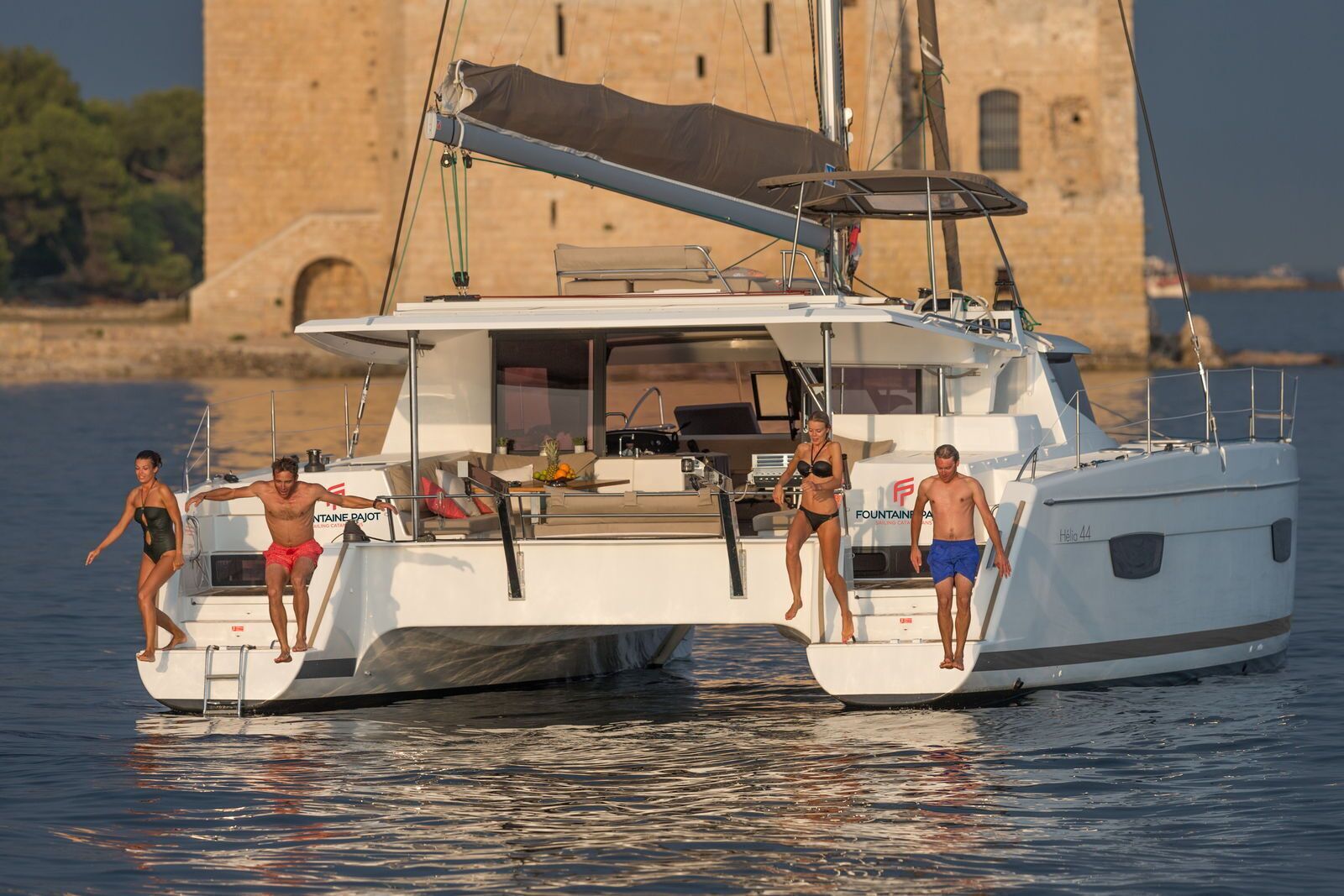 A yacht with a covered deck, a lounge area, and a helipad.