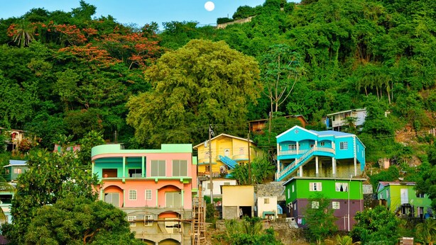 A hillside residential area with colorful houses, a visible moon, and lush greenery. - Caribbean Bliss: Sun-soaked Sailing Adventure from San Vicente y las Granadinas (Ribishi)