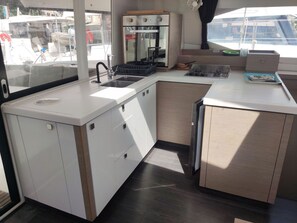 A compact kitchen with a sink, stove, and oven.