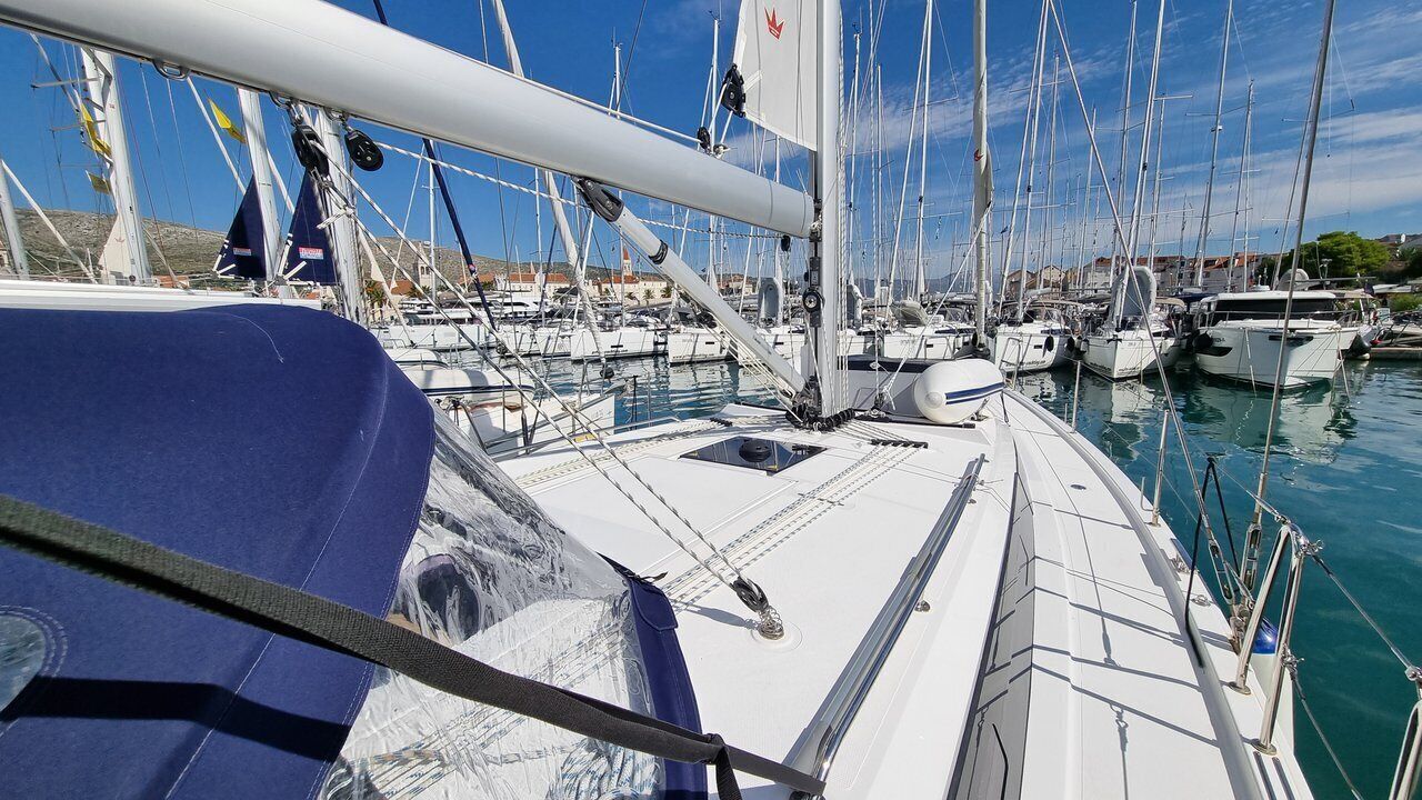 A marina with multiple sailboats docked.