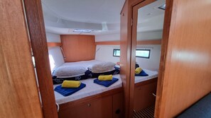 A compact cabin with a bunk bed, a small window, and a door. - Sun-kissed Sailing Adventure in Split-Dalmatia, Croatia (Trogir)
