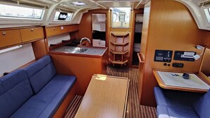 A compact galley with a sink, stove, and storage cabinets. - Sun-Kissed Sailing Adventure in Zadar, Croatia (Bibinje)