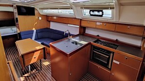 A compact galley with a sink, stove, and storage cabinets. - Sun-Kissed Sailing Adventure in Zadar, Croatia (Bibinje)