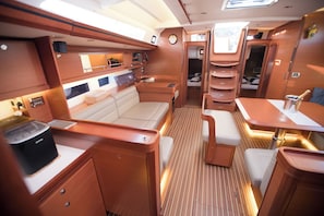 A compact, well-lit interior with a dining area, seating, and a small kitchenette. - Sun-Kissed Sailing Adventure in Sibenik, Croatia (Primošten)