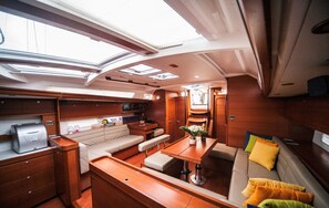 A yacht interior with a dining area, seating, a kitchen, and a galley. - Sun-Kissed Sailing Adventure in Sibenik, Croatia (Primošten)