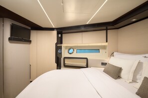 A modern hotel room with a bed, a flat-screen TV, and a built-in heater. - Sibenik Sun and Beach Sailing Extravaganza (Skradin)