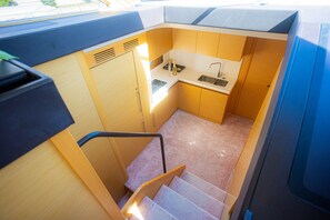 A compact kitchen with a sink, countertop, and a small window. - Sun-Kissed Sailing Adventure in Zadar, Croatia (Bibinje)