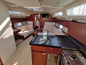 A compact galley with a stove, sink, and storage cabinets. - Sun-Kissed Sailing Adventure in Zadar, Croatia (Bibinje)