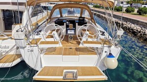 A yacht with a wooden deck, a steering wheel, and a control panel. - Sun-Kissed Sailing Adventure in Zadar, Croatia (Bibinje)