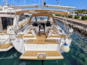 A yacht with a wooden deck, a steering wheel, and a control panel. - Sun-Kissed Sailing Adventure in Zadar, Croatia (Bibinje)