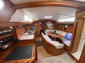 A compact galley with a sink, a small table, and a cushioned seating area. - Sun-Kissed Sailing Adventure in the Ionian Islands (Kontokali)