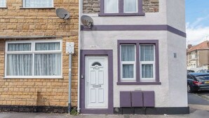 A two-story house with a white door marked '0155', satellite dishes, and a driveway with parked cars. - Central Bristol Luxury Apartment w/ Fast WiFi, (Redfield)