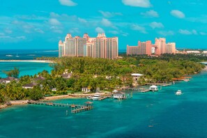 A coastal resort with multiple high-rise buildings, a pier, and a marina.