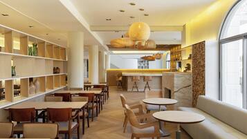 Un interior moderno con muebles de madera, una zona de estar central y una barra.