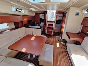 A compact interior with a dining area, seating, and a small kitchenette. - Sun-Kissed Sailing Adventure in Zadar, Croatia (Bibinje)