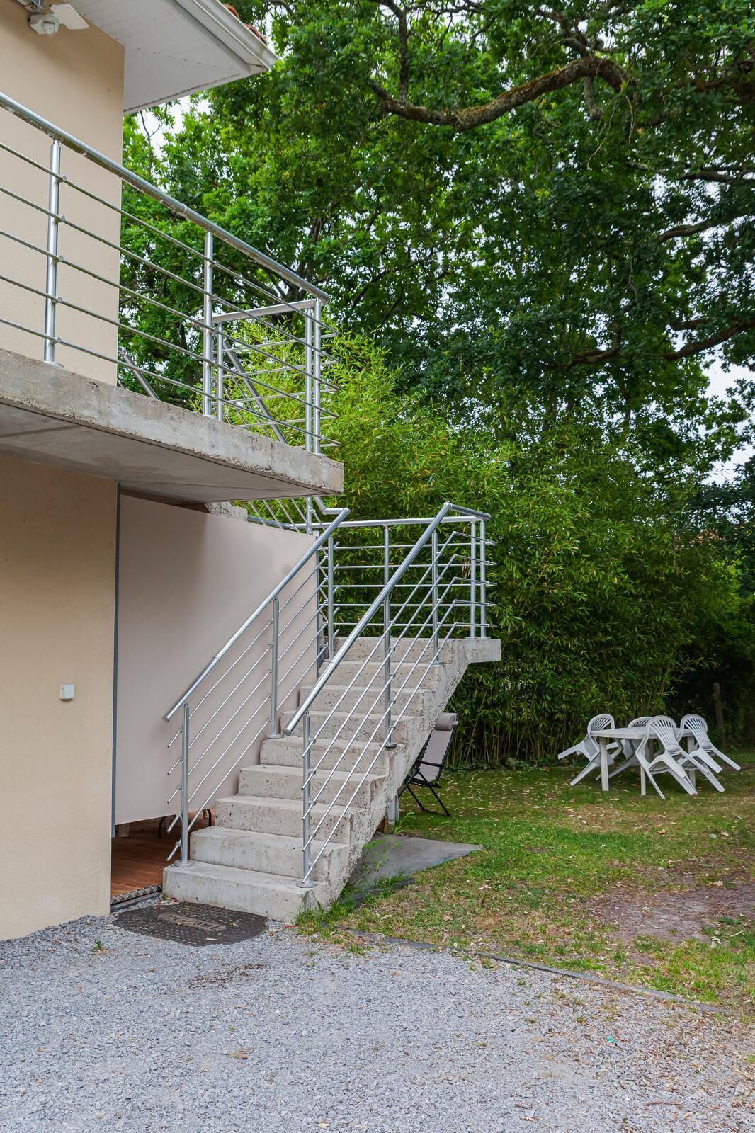 A concrete staircase with metal railings leading to a building entrance.