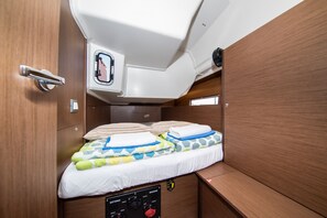 A compact cabin with a bed, a small window, and a control panel for the boat's systems. - Sun-Kissed Sailing Adventure in Zadar, Croatia (Zadar)