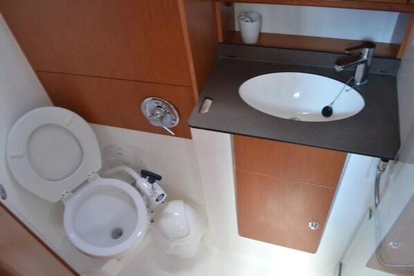 Ein Badezimmer mit Toilette, Waschbecken und Dusche.