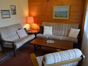 A cozy living room with a sofa set, a coffee table, and a lamp. - Oberland Nr. 29 Appartement/Fewo, Dusche oder Bad, WC 6-Bettwohnung by Interhome (Gstaad)